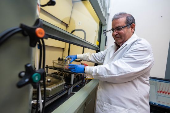 Hoshang Unwalla sets up the smoking robot. The octagonal chamber on the left contains the cigarettes. The one on the right is where HIV cells are exposed to their smoke.