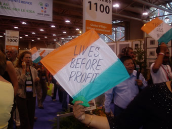 AIDS 2006: Treatment activists carry flags that read: LIVES BEFORE PROFIT.