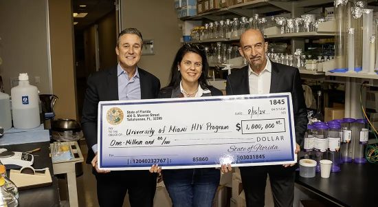 Miami-Dade County Commissioner Rene Garcia, Florida State Senator Ana Maria Rodriguez and Mario Stevenson, Ph.D., co-director of the Miami CFAR, at the check presentation.